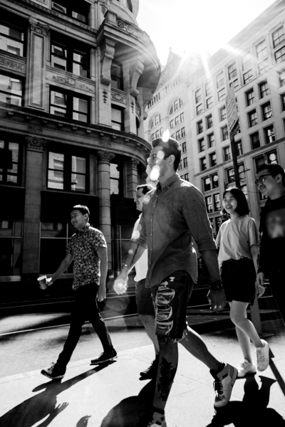 Pedestrians crossing a busy New York City intersection, reflecting the hustle and bustle of the city.